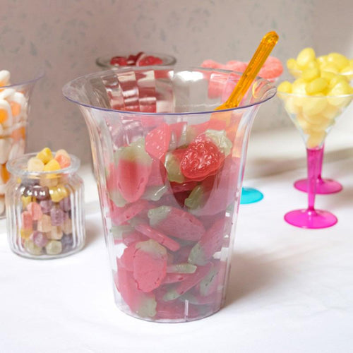 A large transparent plastic party jar filled with strawberry sweets