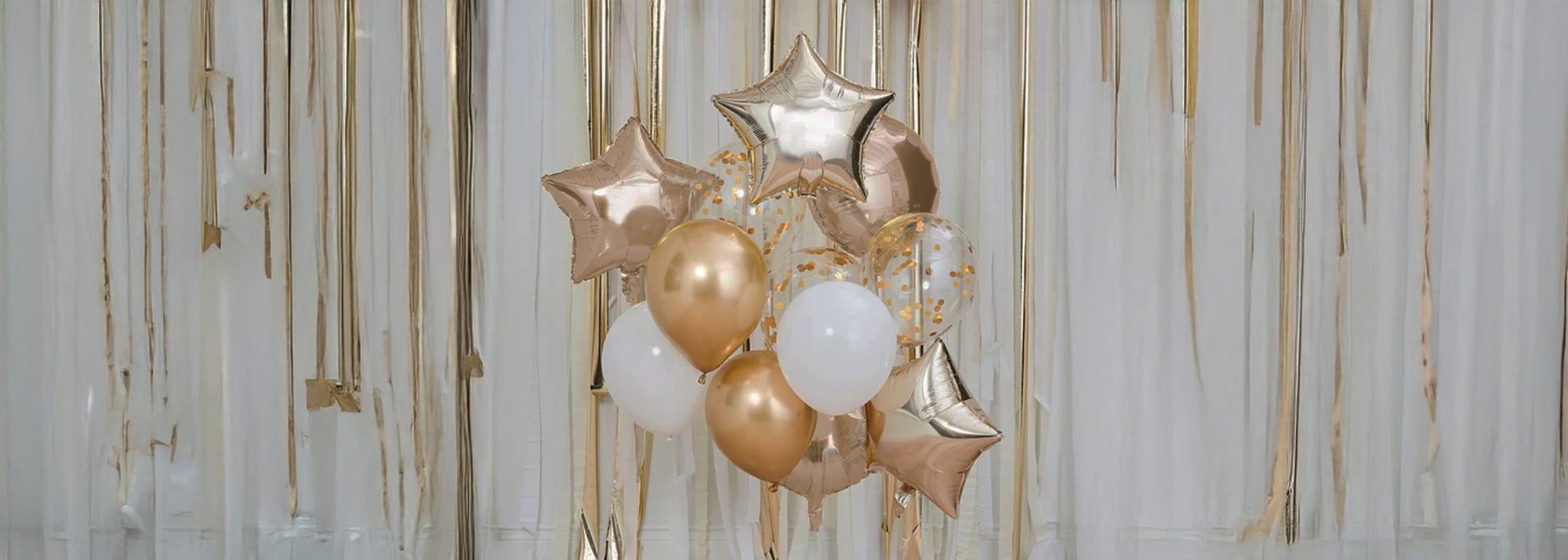 Decorative setup with balloons and streamers on a plain background