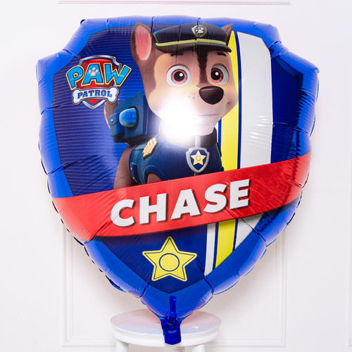 A Paw Patrol-themed helium balloon featuring the character Chase