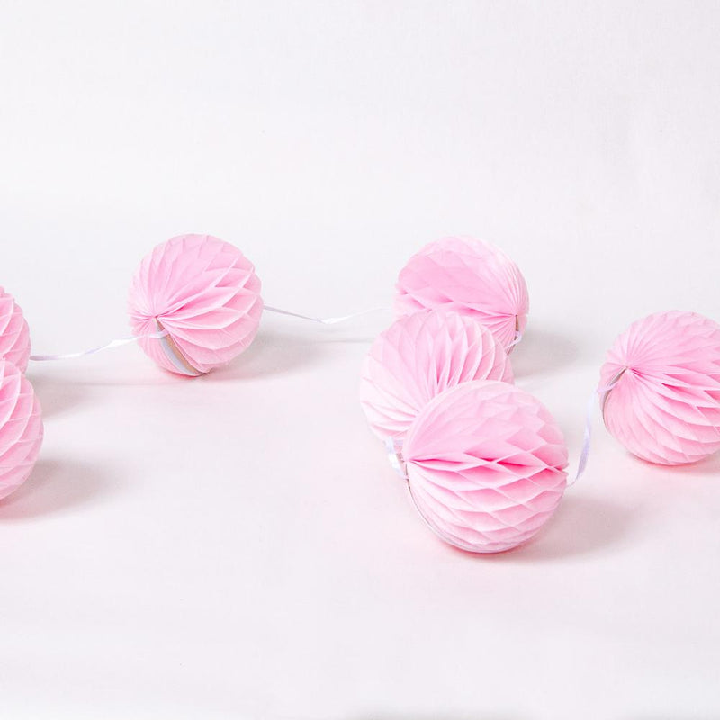 A bunch of light pink party pom poms