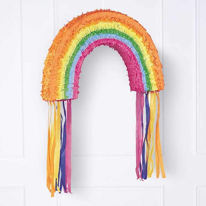 A large, colourful rainbow party pinata with tassel streamers