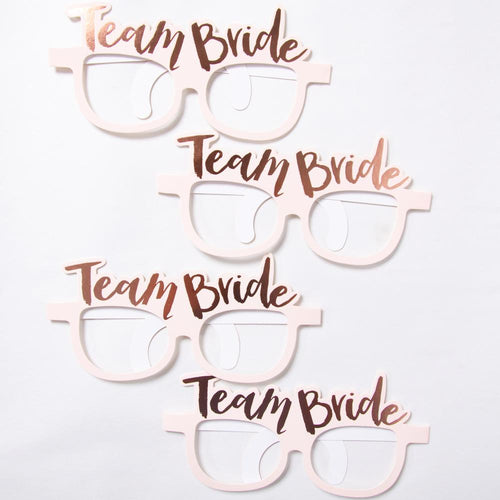 4 pastel pink hen party glasses with a rose gold foil "Team Bride" phrase on top