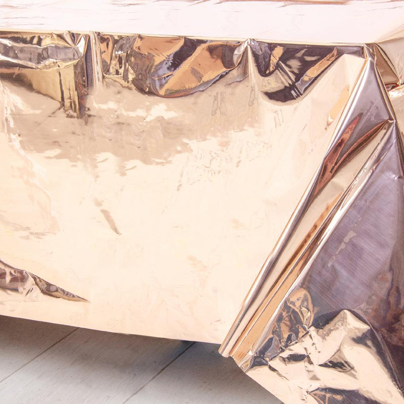 A shiny rose gold-foiled plastic table cover