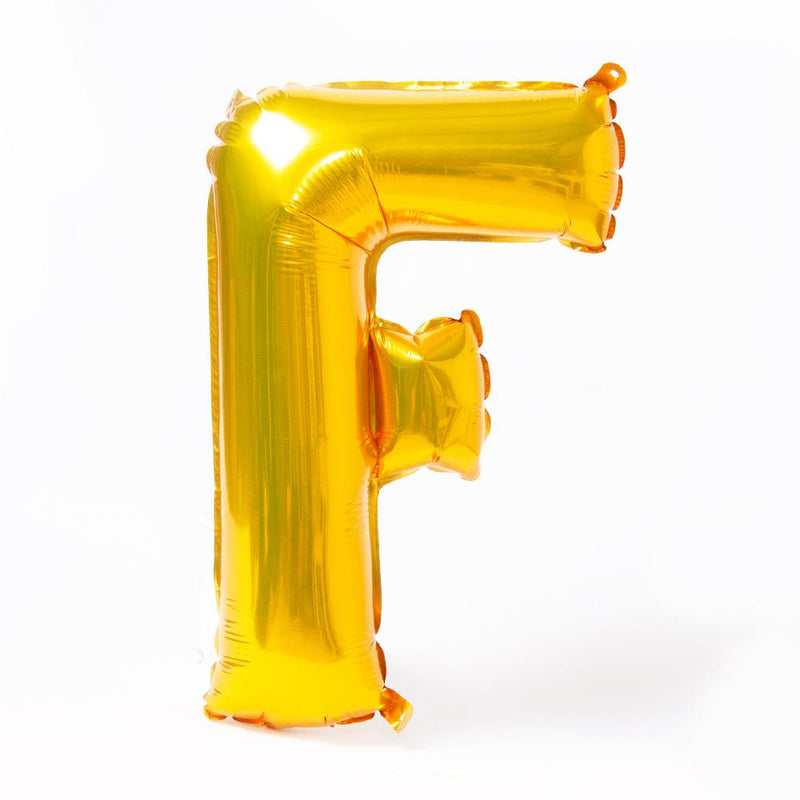 A shiny metallic gold letter "F" balloon