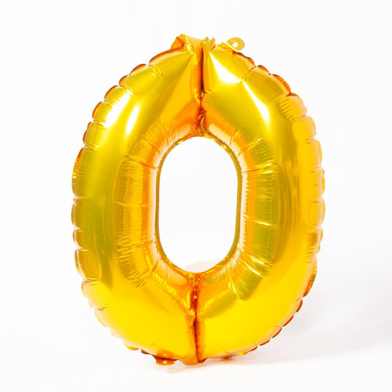 A shiny metallic gold letter "O" balloon