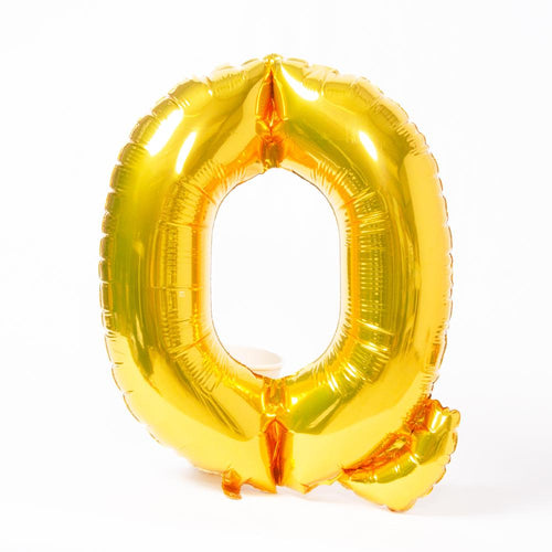 A shiny metallic gold letter "P" balloon