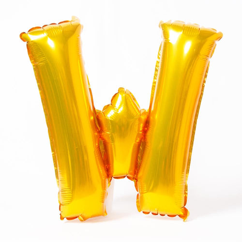 A shiny metallic gold letter "W" balloon
