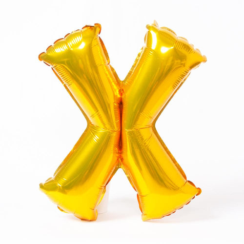 A shiny metallic gold letter "X" balloon