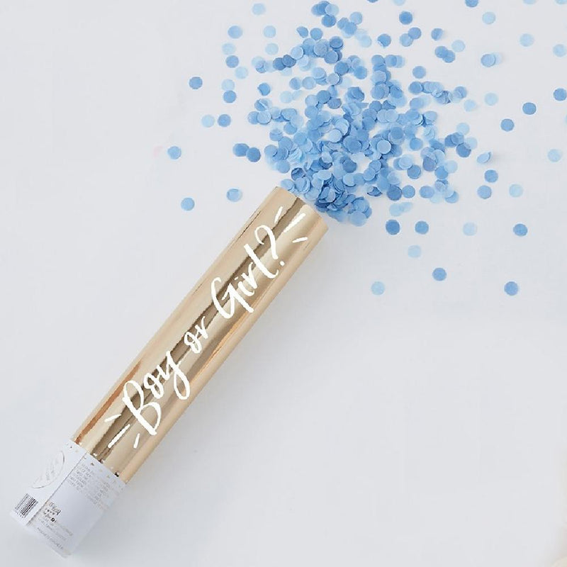 A gold gender reveal confetti cannon with a burst of blue confetti shooting out the top