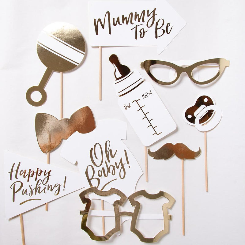 A collection of baby shower party photo booth props laid out on a white background