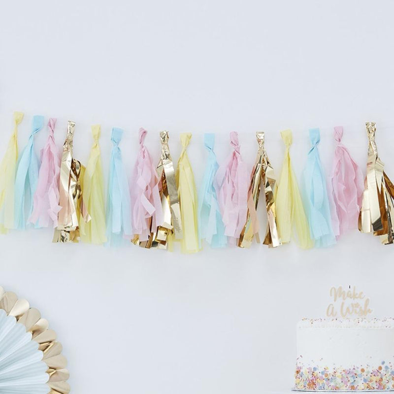 A party garland made up of pastel-coloured and gold foil tassels