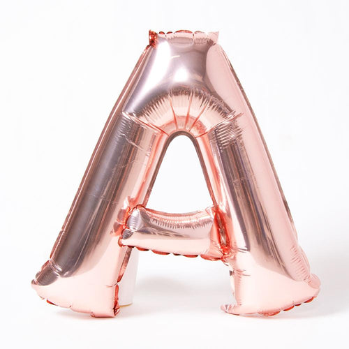 A rose gold foil balloon in the shape of the letter "A"
