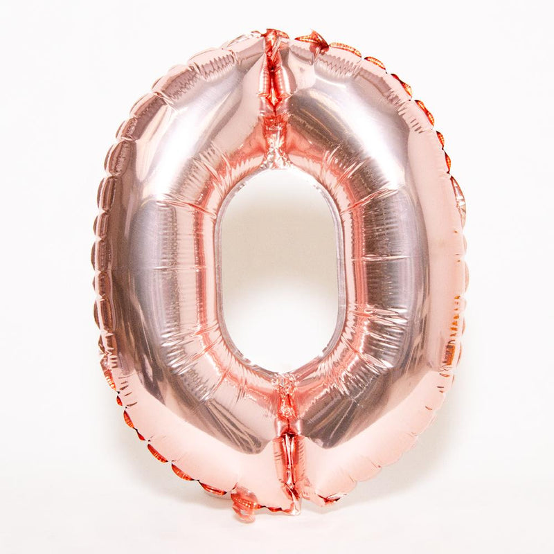 A rose gold foil balloon in the shape of the letter "O"