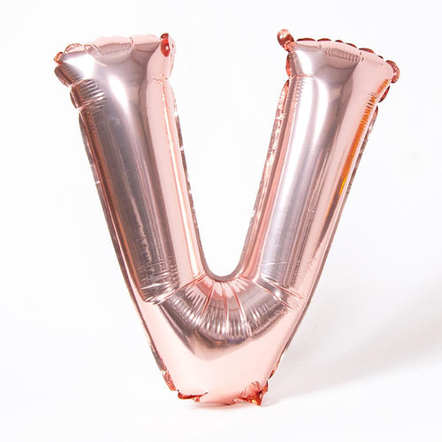 A rose gold foil balloon in the shape of the letter "V"