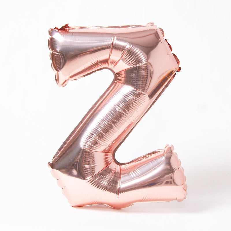 A rose gold foil balloon in the shape of the letter "Z"