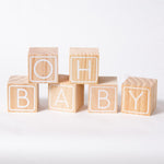 A set of baby shower wooden baby blocks with the phrase "Oh Baby"