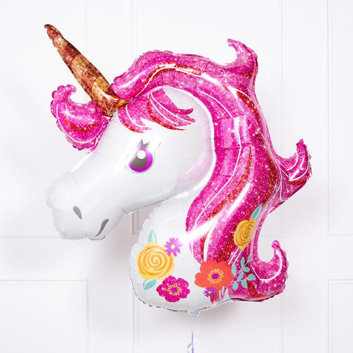 A floating unicorn-themed balloon with gold horn and pink mane