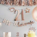 A rose gold party banner with a "let's celebrate" phrase and a customisable party number
