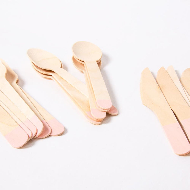 A set of wooden party cutlery with light pink handles