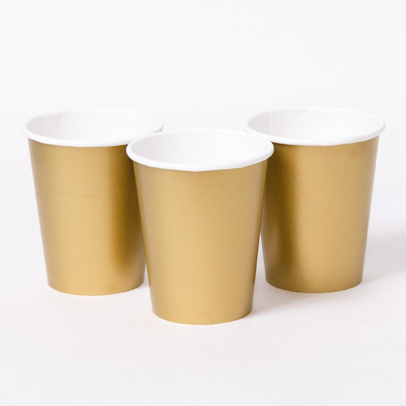 3 matte gold party cups with white rims